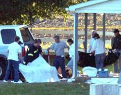 Law enforcement personnel carry a body bag out of a one-room Amish schoolhouse in Paradise, Pennsylvania, on Monday. Earlier that day a milk truck driver stormed into the schoolhouse and fatally shot five girls before killing himself. Six students remain in critical condition.