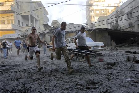 Lebanese men run to help survivors after an Israeli bomb destroyed two six-storey high buildings in Tyre, July 26, 2006. REUTERS/Nikola Solic. Suggestion: Avoid living near Hezbolla missile launching sites