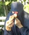 woman in burqa eating pizza
