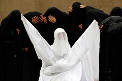 Shi'ite women take part in a re-enactment of the battle of Kerbala during an Ashura procession in Istanbul. 