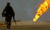 A US soldier walks towards a burning oil well in Iraq's vast Rumaila oil fields in this March 2003 photo: Even directly after the invasion, the US troops didn't pay close attention to the issue of oil.