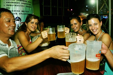 tourists enjoy themselves at the 21st International Beer Festival at the beer city in Qingdao