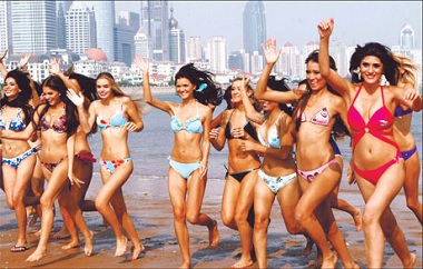 Finalists of the 36th Miss Bikini International World Contest pose for a photo at a beach in Qingdao