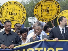 Rev. Jesse Jackson, Rev. Al Sharpton, and NAACP President Benjamin Justice lead a NAACP march and rally for Trayvon Martin in front of the Sanford Police Department in Sanford, Florida, Saturday March 31.