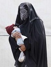 A woman wearing a black burqa holds her baby while waiting to receive a medical check-up at a make-shift military clinic for internally displaced persons (IDPs) in Dera Ismail Khan, located in Pakistan's restive North West Frontier Province on November 10, 2009.