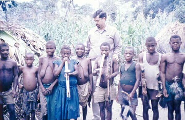 In July 1967 David Mendosa safaried to the Ruwenzori Mountains (between Uganda and the Congo) where he came across this group of Pygmies. David is the tall one.