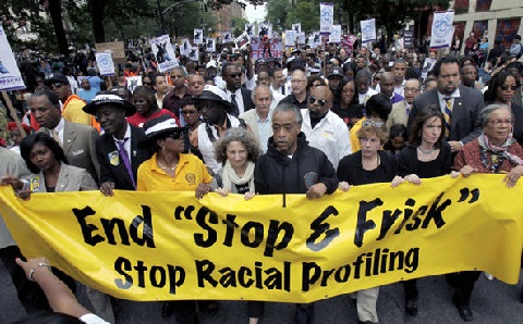 The Rev. Al Sharpton, center, walks with demonstrators during a silent march to end 'stop-and-frisk'