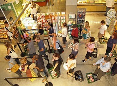 Customers waiting in line to check out at the Whole Foods on Houston Street in New York City's East Village.