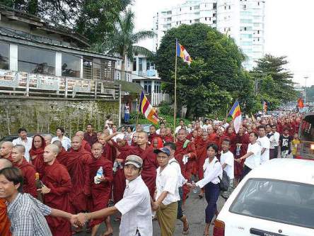 26 September 2007 - Rangoon, Burma (Yangon, Myanmar) Monks march west on Shwegondine Road in Yangon as onlookers join and form a human chain to protect the monks from government forces deployed to crackdown on the demonstrations. 