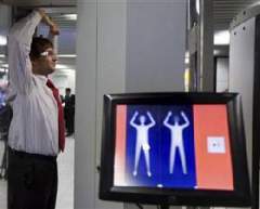 An employee of Schiphol Airport in Amsterdam shows how a body scanner works
