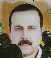 At a rally in Gaza, Hamas fighters stand in front of a portrait of Mahmoud Mabhouh