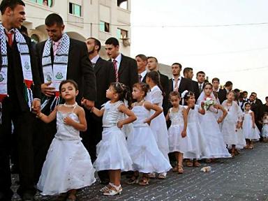 Grooms pose with young relatives during a mass wedding organized by the Palestinian party Hamas August 5, 2005 in the Gaza Strip. The ceremony which featured young girls as a substitute for the men's actual wives, who have a separate ceremony behind closed doors.