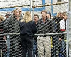 Staff leave a General Motors plant in Oshawa, Canada, after hearing of the job cuts