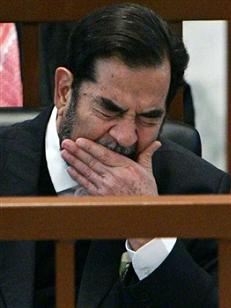 Ousted Iraqi President Saddam Hussein yawns while listening to the prosecution during the 'Anfal' genocide trial in Baghdad December 18, 2006. Prosecutors who accuse Saddam of genocide by ordering chemical attacks on Kurds produced documentary evidence at his trial on Monday in a new phase crucial to pinning down his personal responsibility.