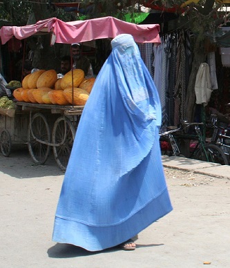 Blue burqa'd woman flying through the streets of Afghanistan.