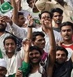 Pakistani people wave national flags