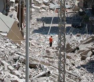 A man stands between destroyed buildings in Beirut's southern suburbs, 31 Jul 2006. Xinhua Photo