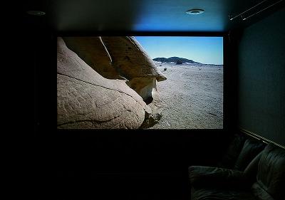 Projection screen in a home theater, displaying an HD-TV image.