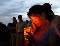 Lan Nguyen from New Orleans, takes part in a candlelight vigil on the levee of Lake Pontchartrain in New Orleans 
