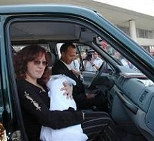The Kartuzov family, shown in June 2007, drive away in their new UAZ-Patriot SUV, which they won as a grand prize in a regional contest titled: Give Birth to a Patriot on Russia's Independence Day.