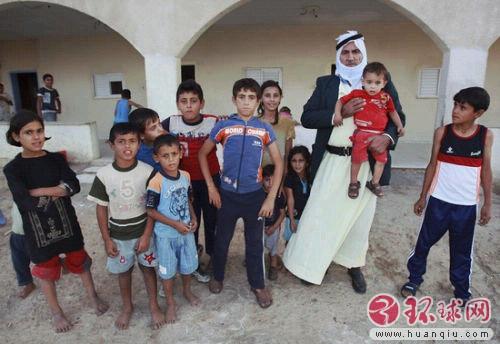 Israeli Bedouin Shahadeh Abu Arar stands with some of his 67 children outside his home.
