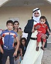 Israeli Bedouin Shahadeh Abu Arar stands with some of his 67 children outside his home.