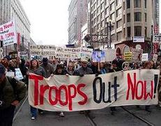About 10,000 Bay Area residents brave the cold drizzle marching down Market Street in downtown San Francisco to express their opposition to Bush's Troop Surge.
