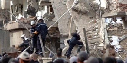 Rescue workers at the site of one of the bomb blasts in Algiers on Tuesday. (The Associated Press)