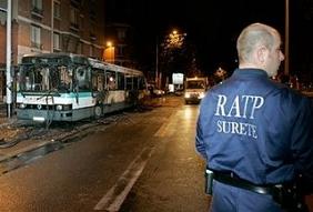 A French security public transport operator, from RATP, watches over the remains of a city bus Wednesday, Oct. 25, 2006, at the bus station of Nanterre, west of Paris. The bus was set on fire on Wednesday night in Nanterre by a gang of youths, after they forced passengers out. (AP)