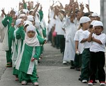 Filipino Muslim children show hand signs for peace as they march in suburban Bicutan, south of Manila, Sunday, Jan. 20, 2008. 