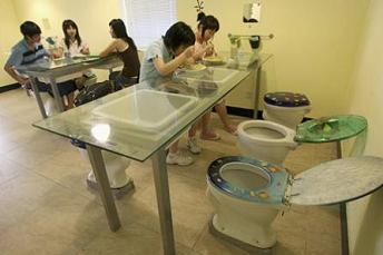 Diners have their meals on toilet seats at a toilet-themed restaurant in Hangzhou in Zhejiang province