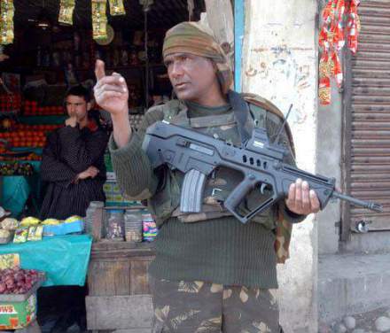 March 01, 2008: An Indian trooper holding an Israel made Tavor Assault Rifle (TAR-21) at a market in the center of the Kashmir valley. The rifles developed by Israel for usage in urban warfare are part of India's strategy to modernize its army especially while dealing with Muslim terrorists in the country.