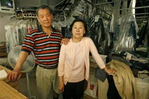 Jin Nam Chung and Ki Chung stand inside of their dry cleaning business, Custom Cleaners, in Washington on Wednesday, May 2, 2007. The Chung's are being sued for 65 million dollars over a contentious pair of pants belonging to a local judge, and for using signs that the judge claims were deceptive. (AP Photo/Jacquelyn Martin)