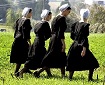 Four Amish girls walk to the home of one of the girls that was killed yesterday at the one room Amish schoolhouse shooting October 3, 2006 in Nickel Mines, Pennsylvania.