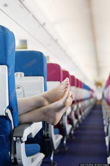 woman with feet on armrest