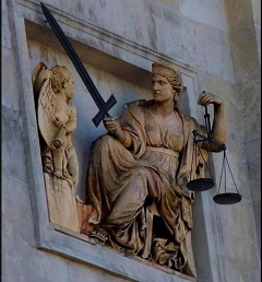 The Law, carrying the sword and scales of Justice